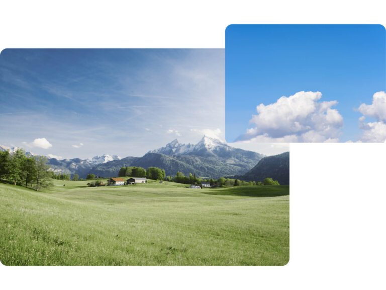 Beautiful view of idyllic alpine mountain scenery with blooming meadows and snowcapped mountain peaks on a beautiful sunny day with blue sky in springtime and a cloud in the sky.