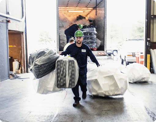 An Agilyx employee carrying waste styrofoam in the plastic recycling facility in Tigard, Oregon.