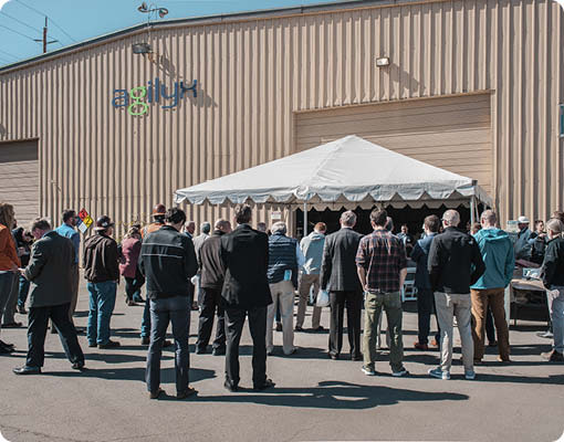 People standing outside at the ribbon cutting ceremony for the Agilyx chemical recycling facility in Tigard, Oregon.